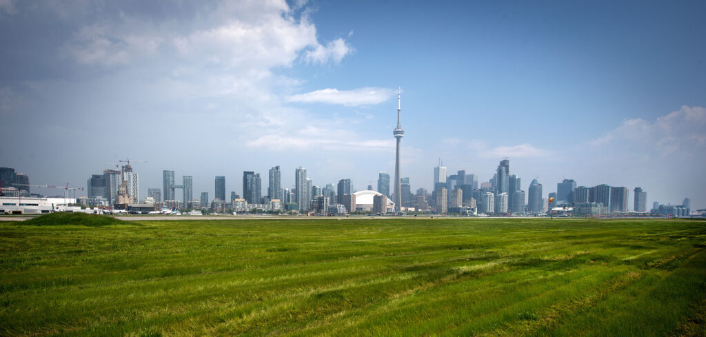 BBTCA with photo taken near runway with city skyline in background