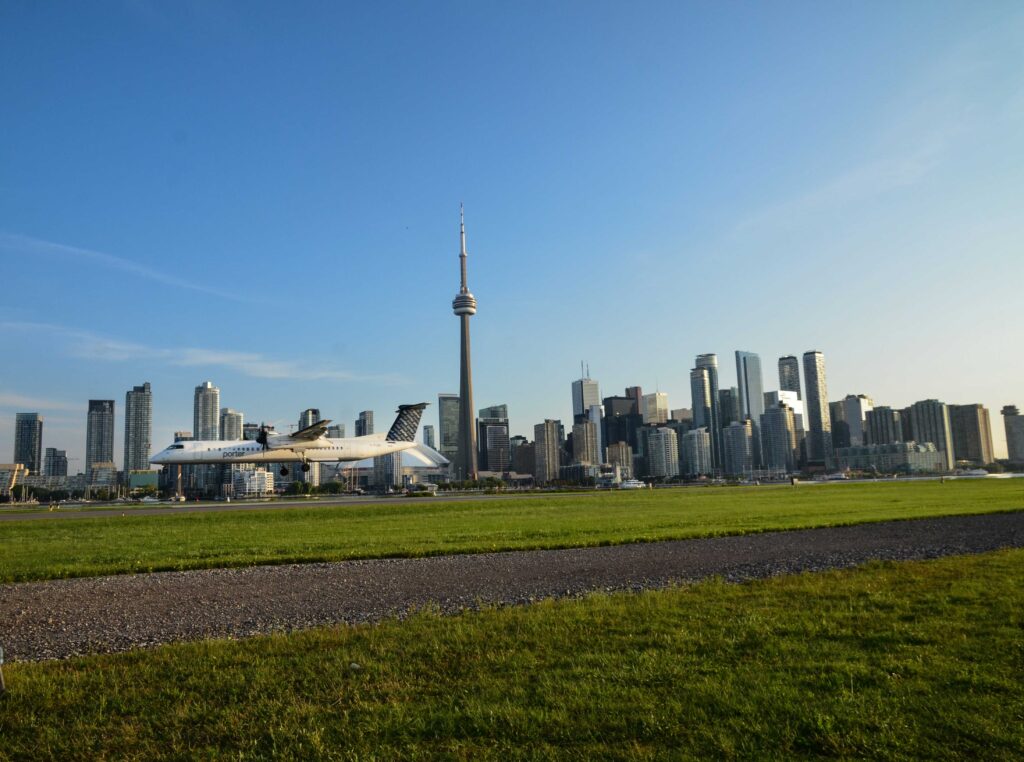 Plane landing with city skyline in background