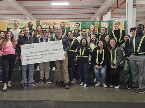 Daily bread food bank staff gathered around cheque photo