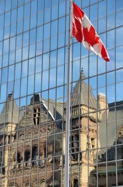 Canadian flag reflection off a building's glass