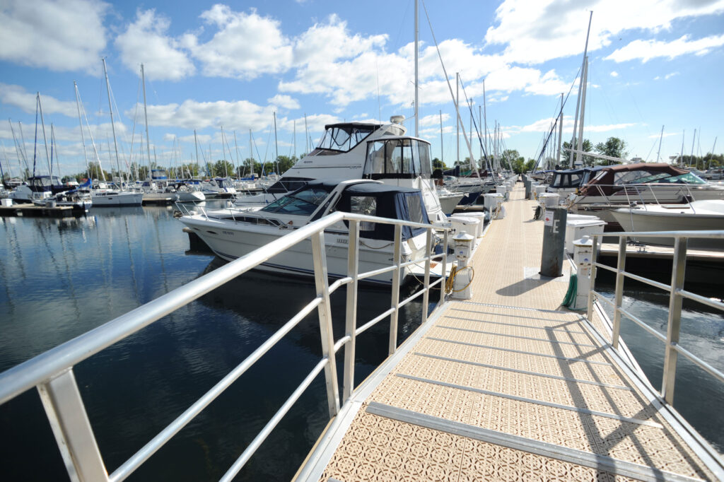 Marina walkway with yacht at the dock