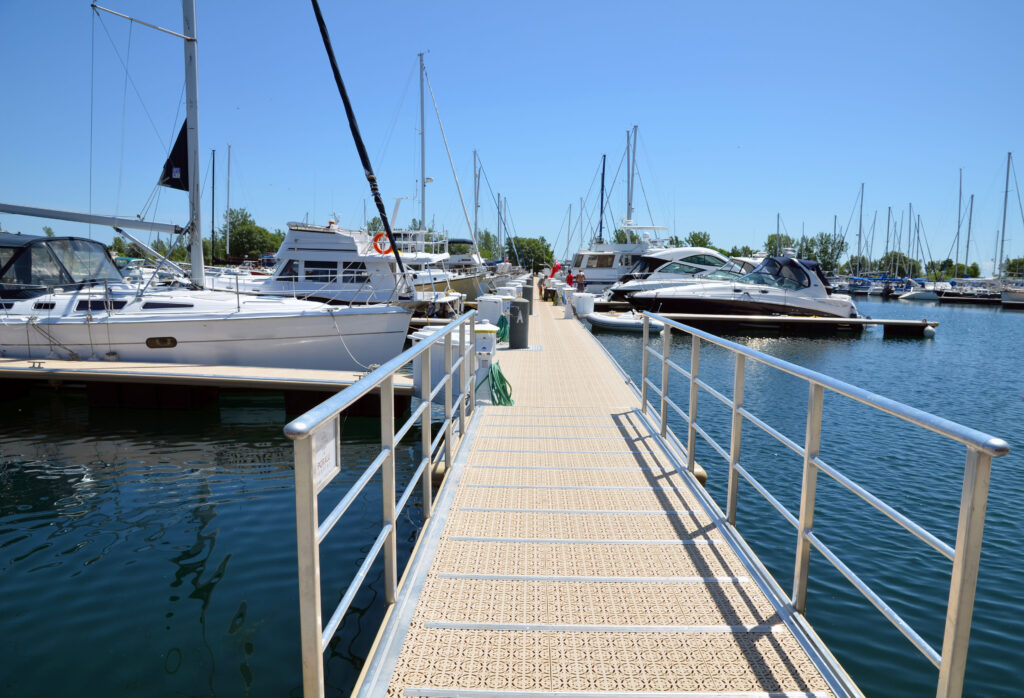 Marina walkway with yacht at the dock