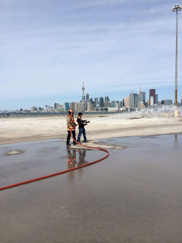 Individual trying out a fire hose