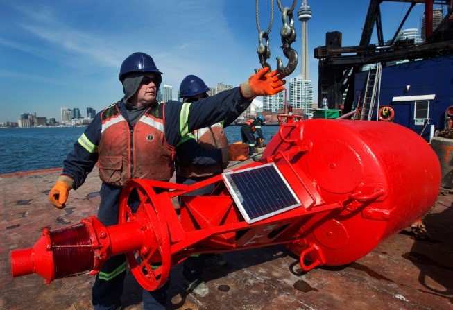 Person with a navigational safety buoy