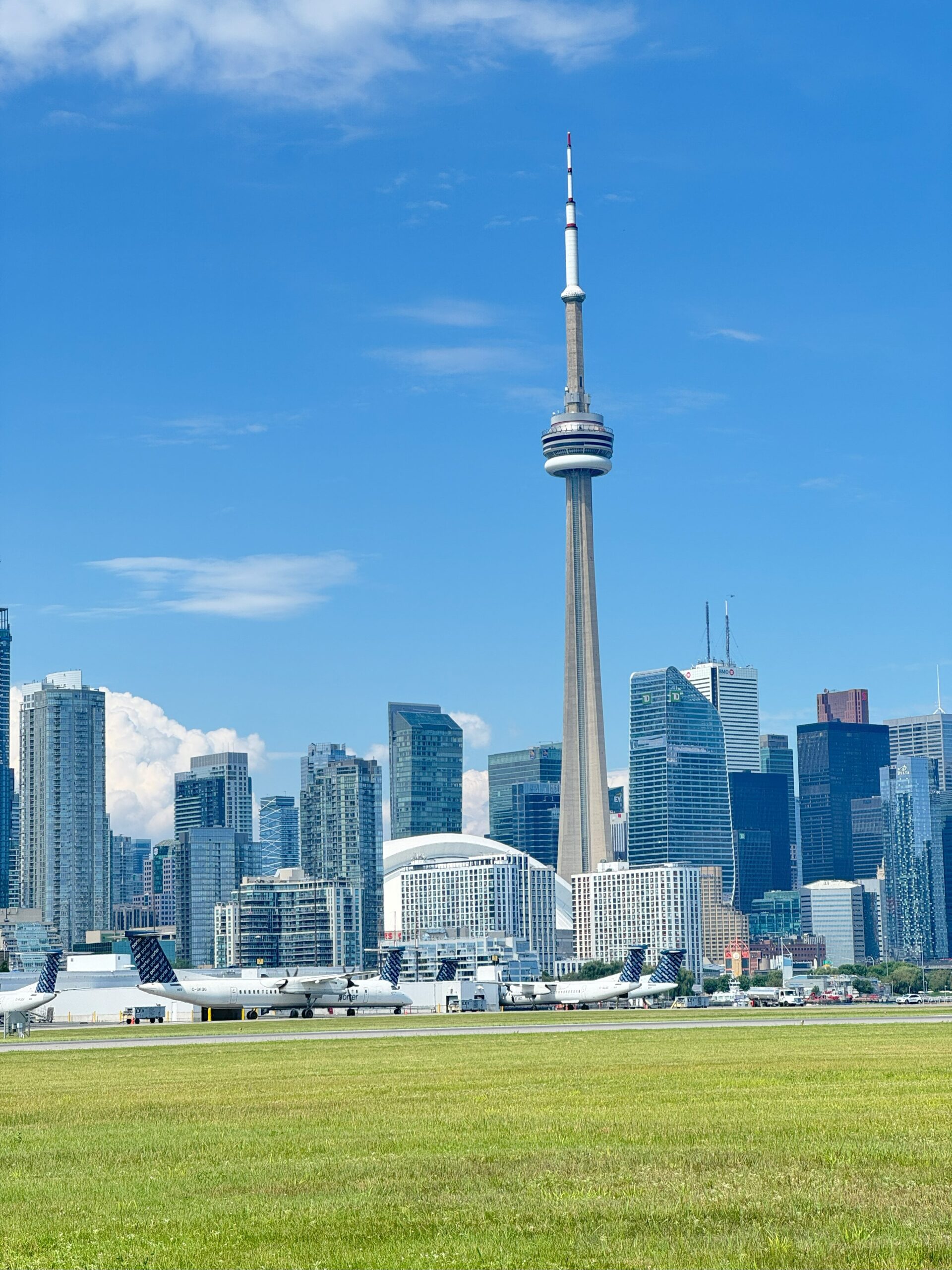 BBTCA with photo taken near runway with city skyline in background