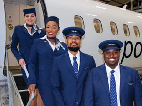 A group of individuals standing on an aircraft stair case