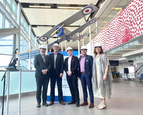 Staff standing with hard hats in the atrium at Billy Bishop Airport